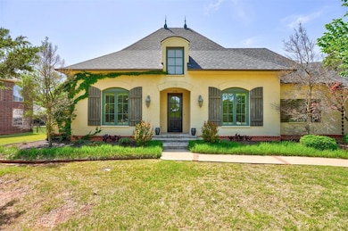 French provincial home with a front yard, stucco s