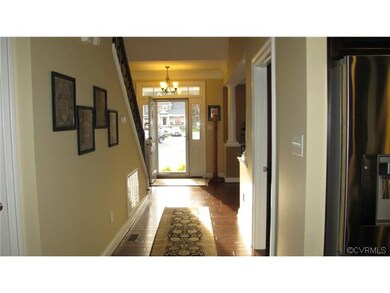Long entry foyer with hand scraped hardwood floors