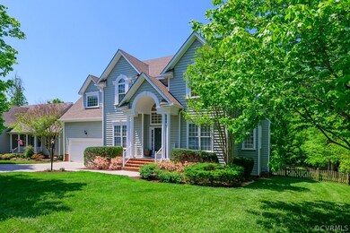 Beautiful covered front porch and lush, green lawn