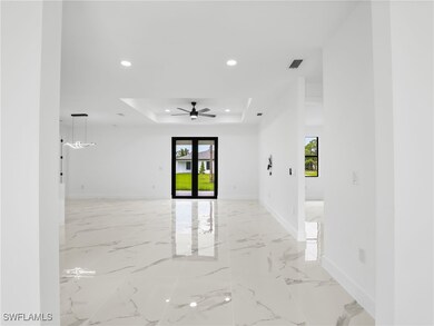 Unfurnished room featuring a raised ceiling, plent