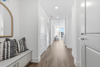 Wide hallway with modern recessed lighting and elegant detail