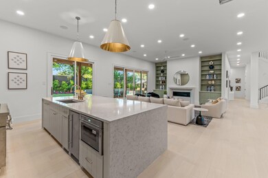 Kitchen with a center island with sink, hanging li