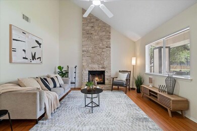Living room featuring visible vents, wood finishe