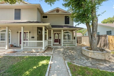 View of front of house featuring a porch and fence