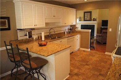 Large eat in kitchen with granite countertops and tile backsplash