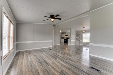Unfurnished living room featuring vaulted ceiling 