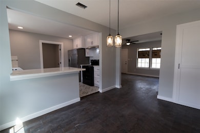 New wood floors in the dining room, living room and all bedrooms. The dining room opens to a brand new and modern kitchen!All light fixtures are new.