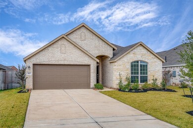 This gorgeous home showcases an attached 2-car garage, brick/stone elevation and lush landscaping.