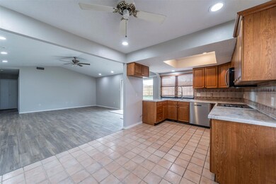 Kitchen with sink, vaulted ceiling, light tile pat