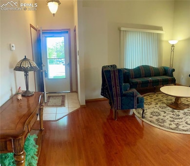 Foyer with wood finished floors and baseboards