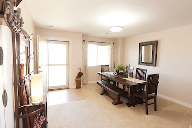 Dining room featuring light carpet and light tile patterned floors