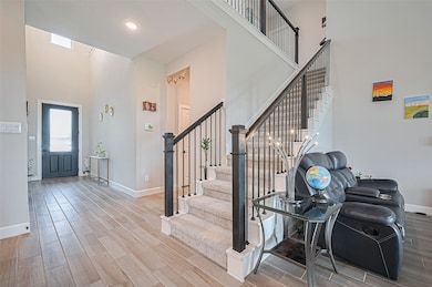 Welcoming entryway with wood-look tile flooring an