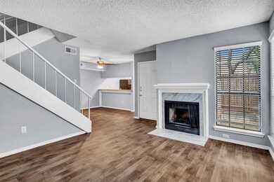 Living room w/ newly tiled fireplace & vinyl plank