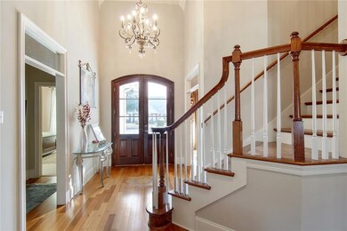 Elegant Foyer with Oversized Doors and Chandelier