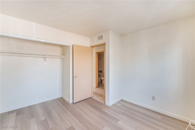 Unfurnished bedroom with light wood-style floors and a closet
