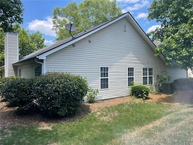 View of property exterior with a yard and a chimney