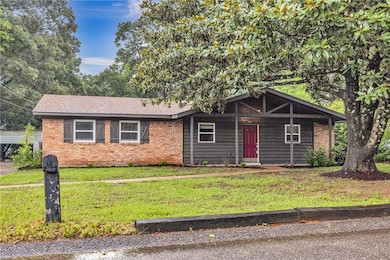 View of front of property with brick siding and a front lawn