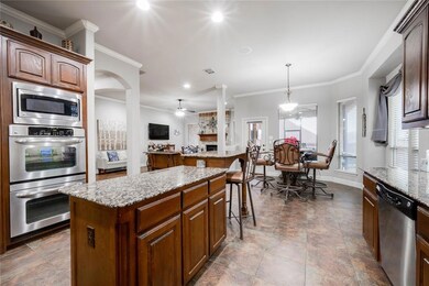 Spacious kitchen boasts granite countertops galore