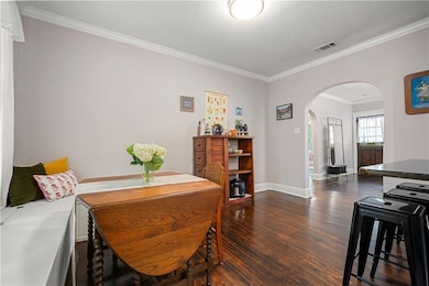 Dining room with dark wood finished floors, visibl