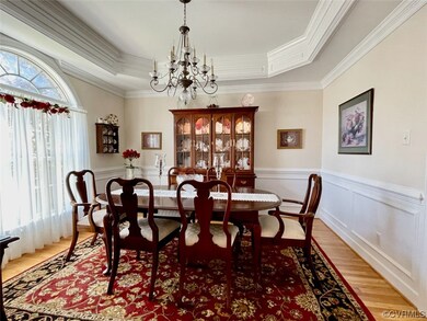 Hardwood floored dining space featuring a chandeli
