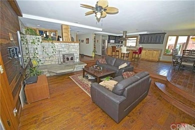 THE SUNKEN LIVING ROOM FEATURING A WOOD BURNING FI