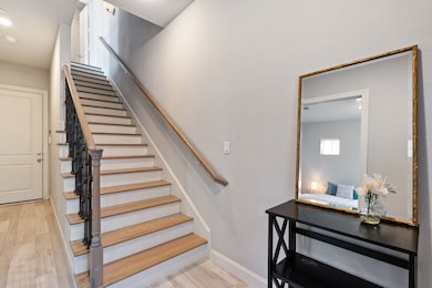Upon entry, you are invited into a welcoming foyer. Staircase with decorative wall sconce leads to the main living spaces on the second floor, while a hallway door provides direct access to the attached 2-car garage. 
