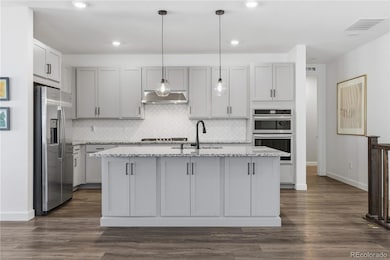 lovely kitchen island with updated fixtures and back splash