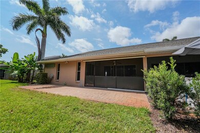 Rear view of house with a lawn, stucco siding, ceiling fan, a patio area, and a sunroom