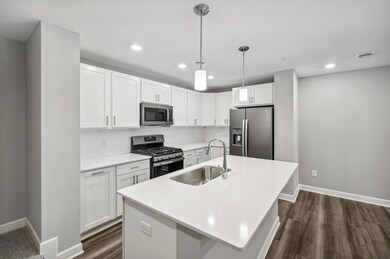Stunning kitchen with Stainless Slate appliances and white cabinetry brighten up the space.