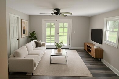 Living area with plenty of natural light, ceiling fan, and dark wood-style floors