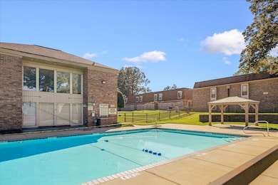 Community pool featuring a gazebo and a patio