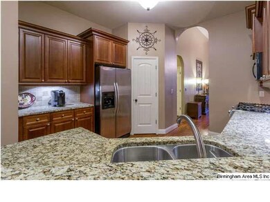 Open kitchen with granite and stainless appliances