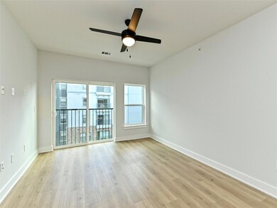 Empty room with ceiling fan, light wood-type floo