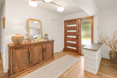 Entryway featuring light wood-style floors, basebo