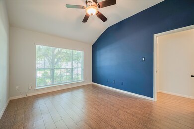 Bright room with modern wood-look flooring, a nine