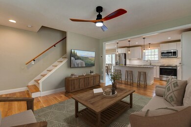 Cozy open concept living and kitchen. Photo virtually staged.