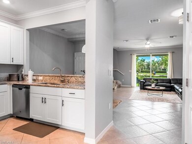Kitchen with ceiling fan, white cabinets, stainles