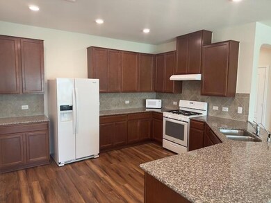 Kitchen with white appliances, dark wood finished