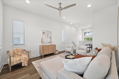 Living room featuring wood finished floors, baseb