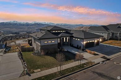 Prairie-style house featuring a mountain view, driveway, a garage, and fence