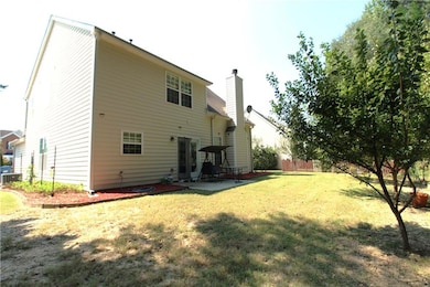 Back of property featuring a patio area and a chimney