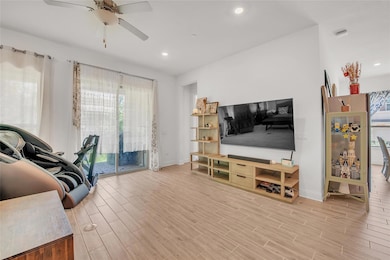 Living area with a ceiling fan, baseboards, light