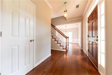 Entryway with dark wood-style floors, an inviting 