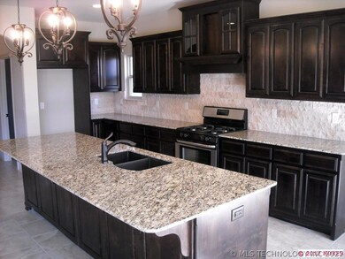 Custom cabinets, pendant lights over granite islan