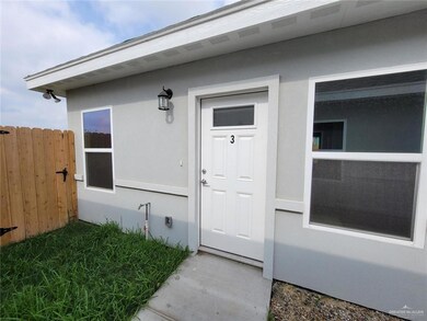 Property entrance featuring stucco siding