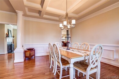 Formal dining room with coffered ceiling, chair ra