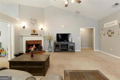 Large living room with vaulted ceiling; brick fireplace