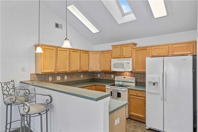 Kitchen with high ceilings and a skylight