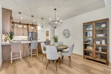 Dining room with recessed lighting, light wood finished floors, and a chandelier