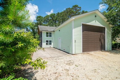 Garage with dirt driveway